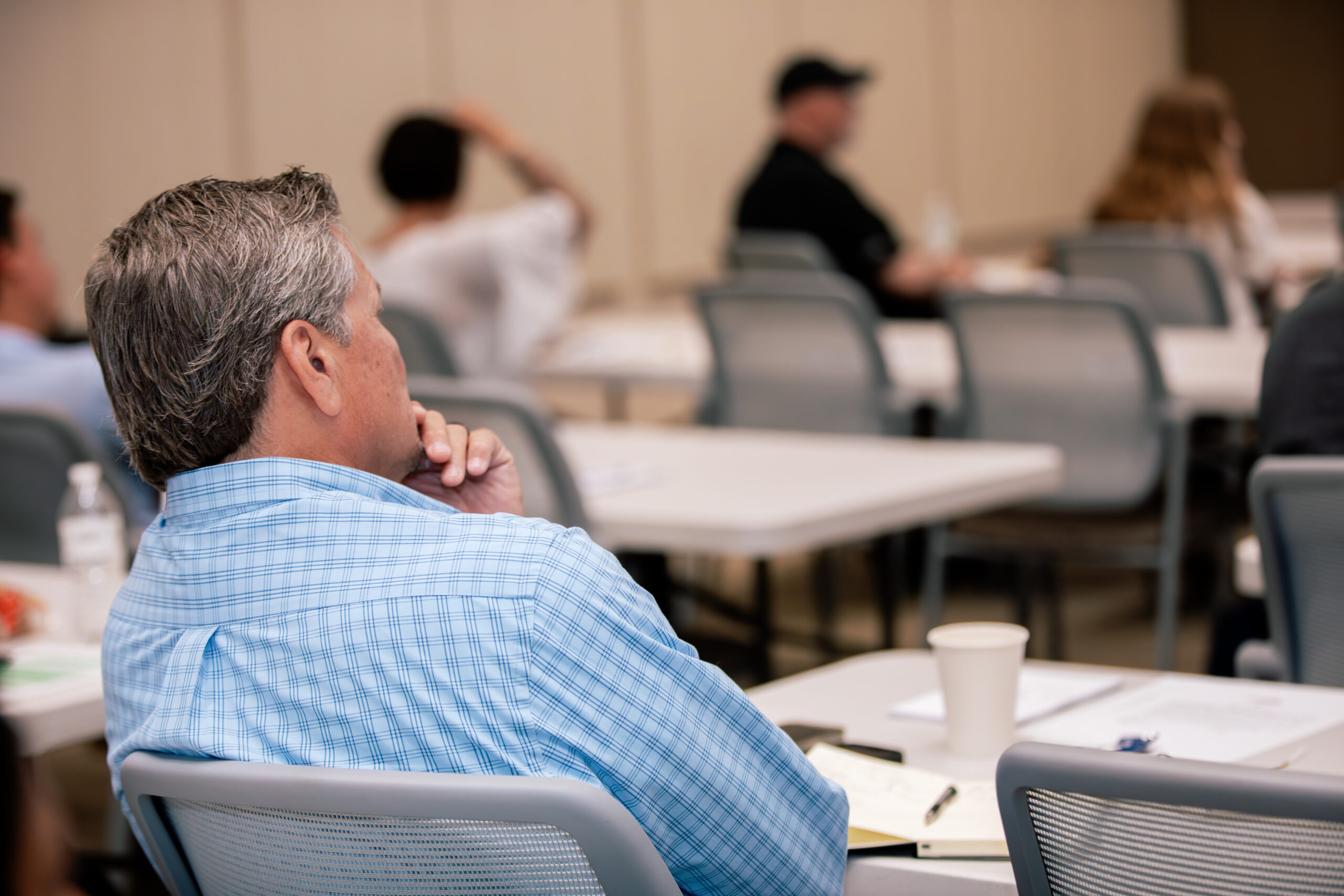 a man listening to a VSMA presentation