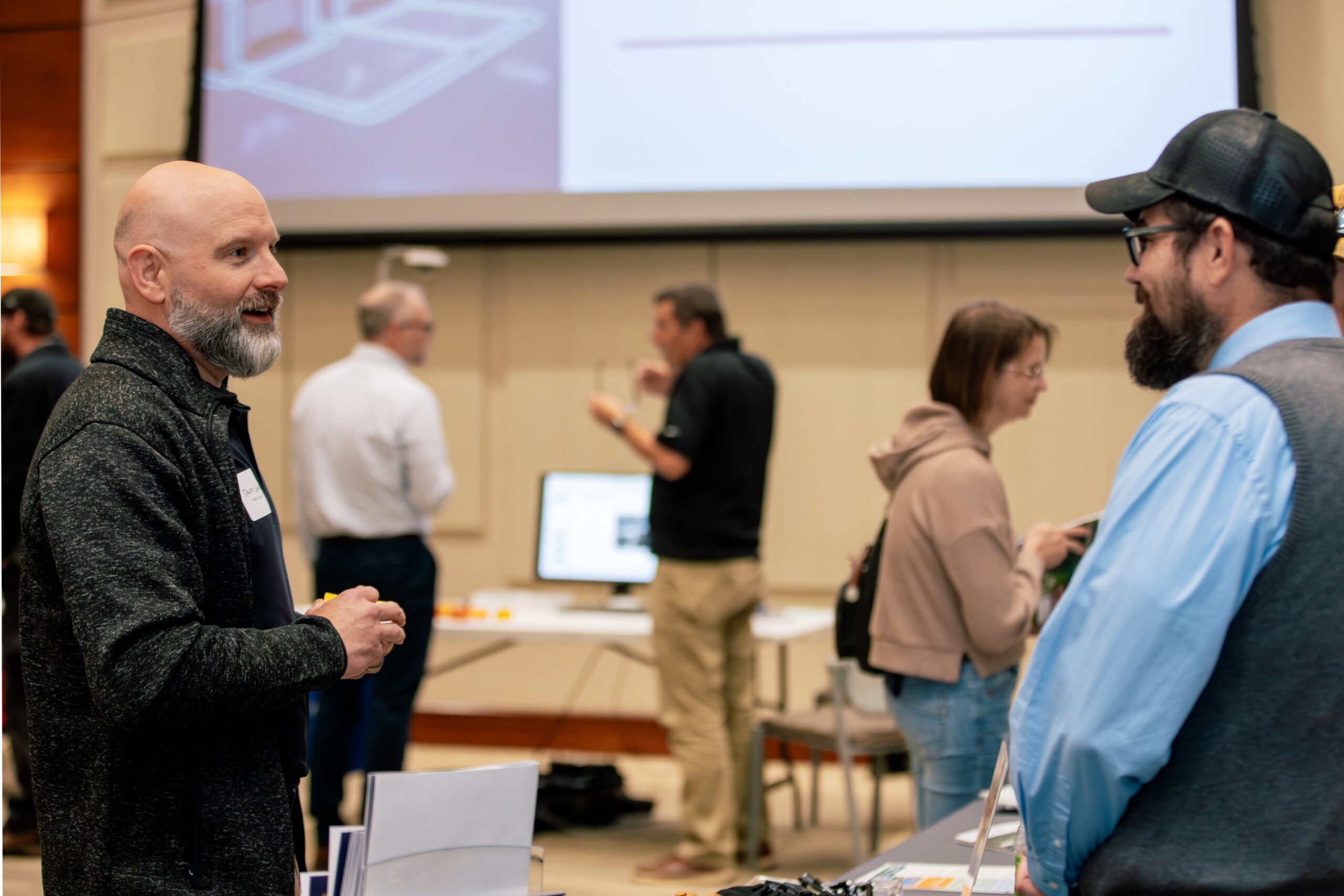 two men speaking at a VSMA Roadshow event